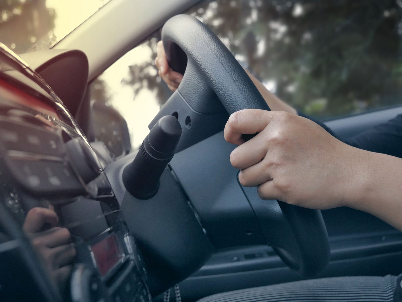 Learner driver's hands on the wheel of a right-hand-drive car